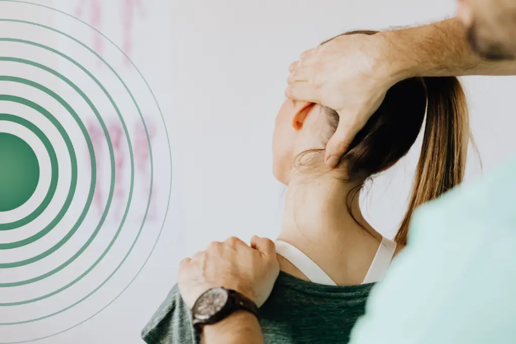 A practitioner performing physio for chronic pain in a patients neck