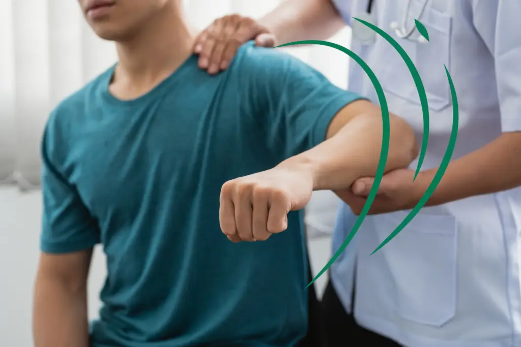 A patient sitting and receiving chiropractic services on his shoulder from a chiropractor